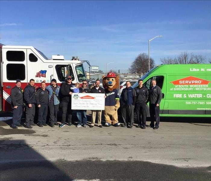 SERVPRO and Worcester Bravehearts presents check to Worcester Fire Department