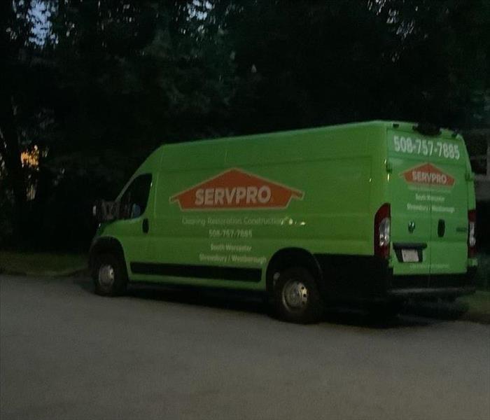 Green SERVPRO truck parked on a job site.