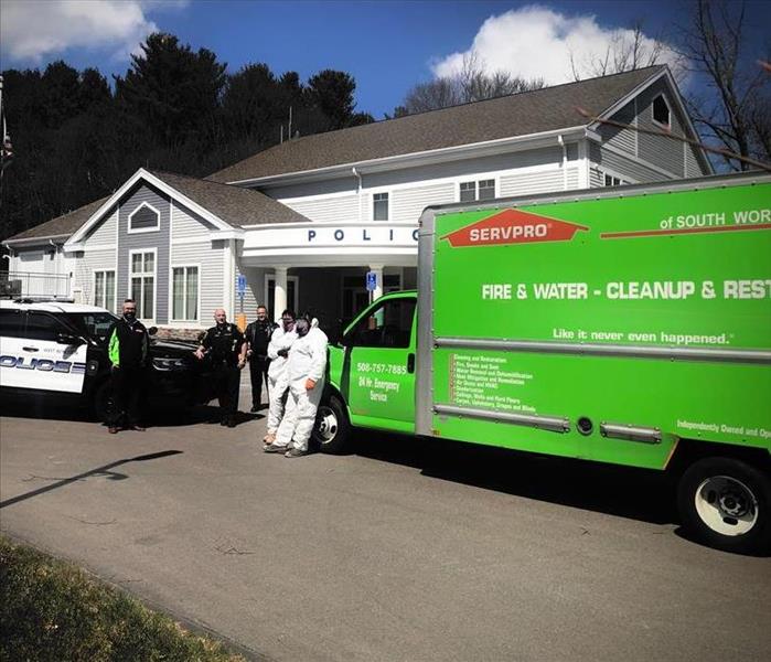 SERVPRO and First Responders in front pf police station and vehicles